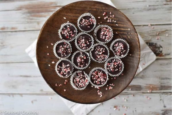Chocolate peppermint cups on a wooden plate.