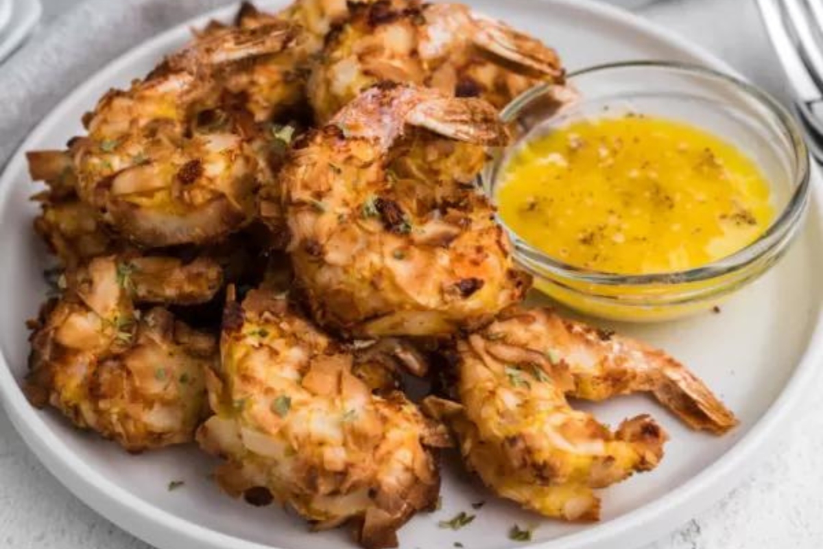 Fried shrimp on a plate with dipping sauce.