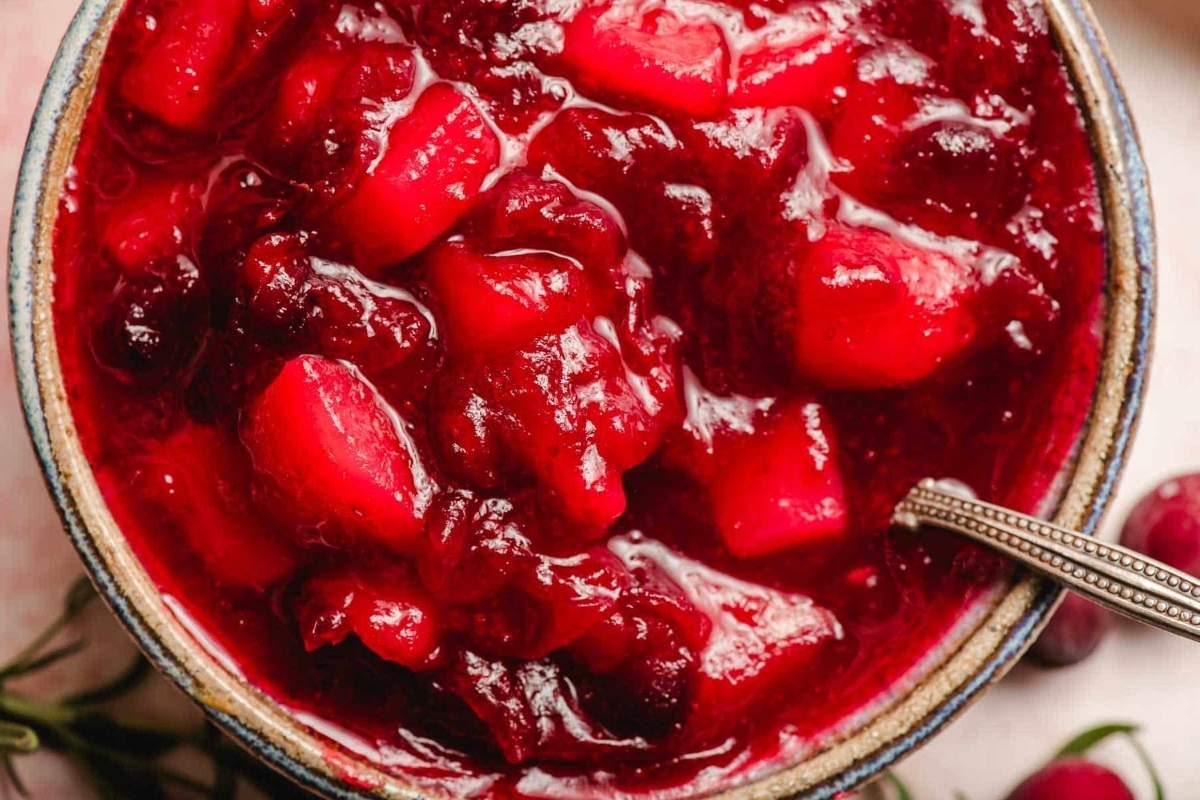 Cranberry sauce recipe in a bowl with a spoon.