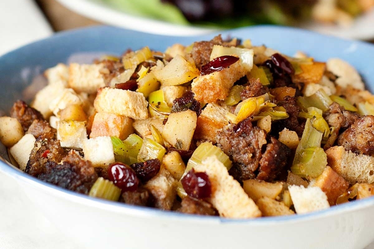A bowl of stuffing with cranberries.