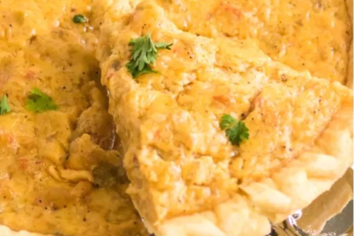 A piece of quiche on a plate with a fork.