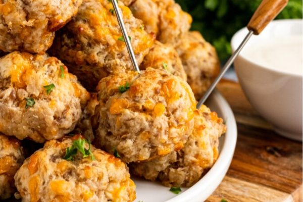 Cheesy meatballs on a plate with a fork.