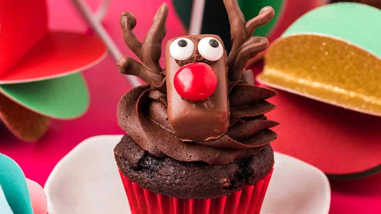 A cute Rudolph cupcake with a red nose, perfect for Christmas.