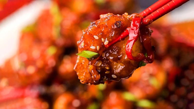 A close up of a Chinese seafood dish with chopsticks.