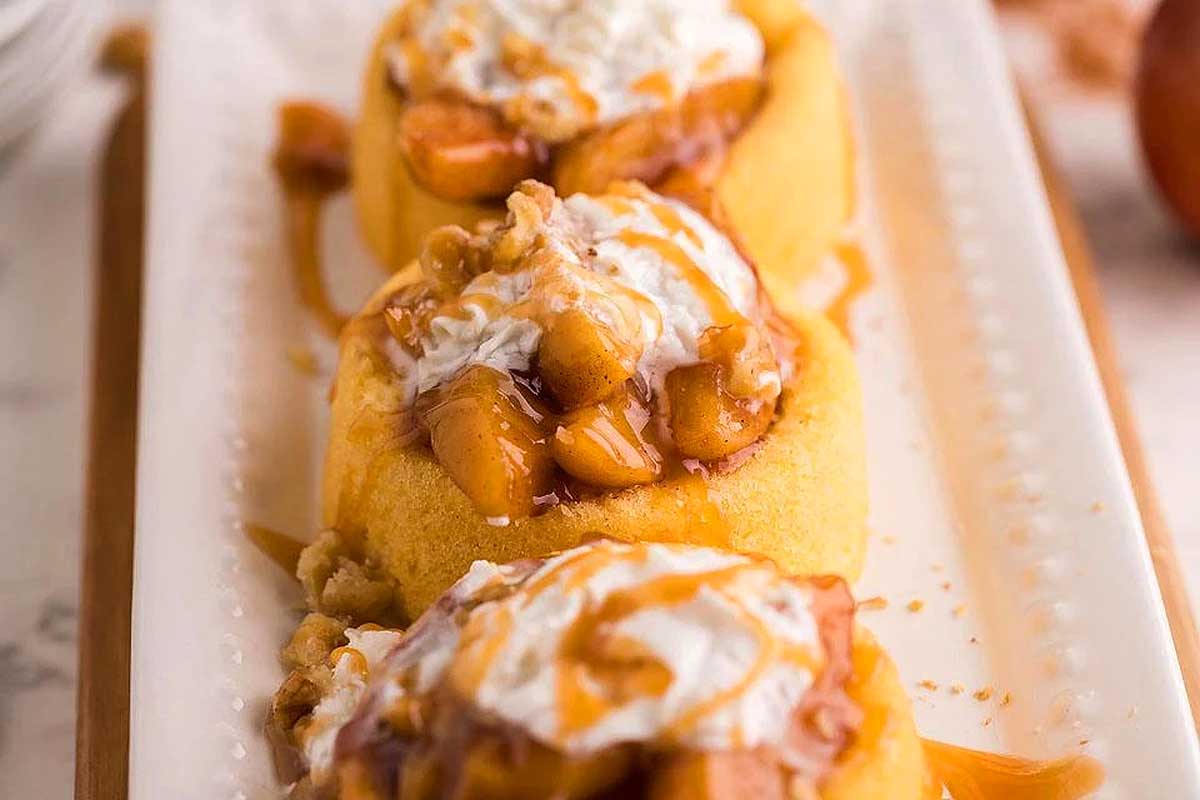 Instant Pot Thanksgiving: A plate of apple cinnamon cupcakes topped with whipped cream and caramel sauce.