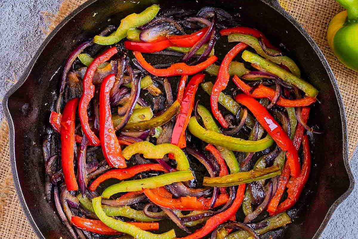 A skillet filled with peppers and onions.