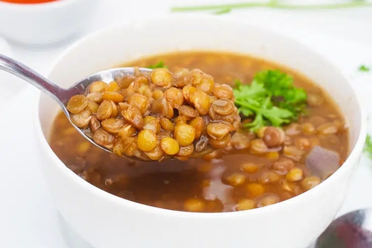 A German lentil soup recipe featuring a delightful bowl of soup with a spoon in it.