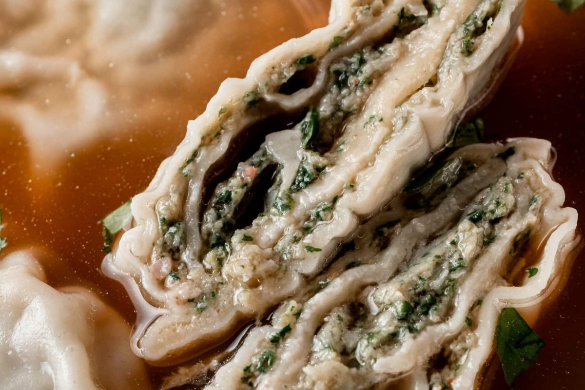 A close up of German dumplings in a bowl of soup.