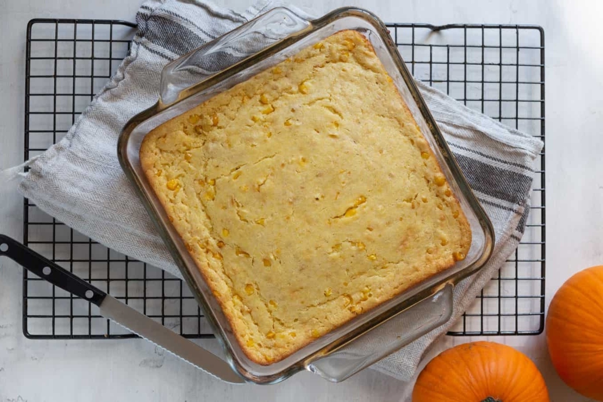 A slice of pumpkin bread on a Thanksgiving cooling rack.