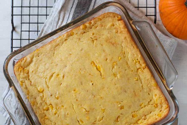 Friends giving pumpkin bread in a glass dish.