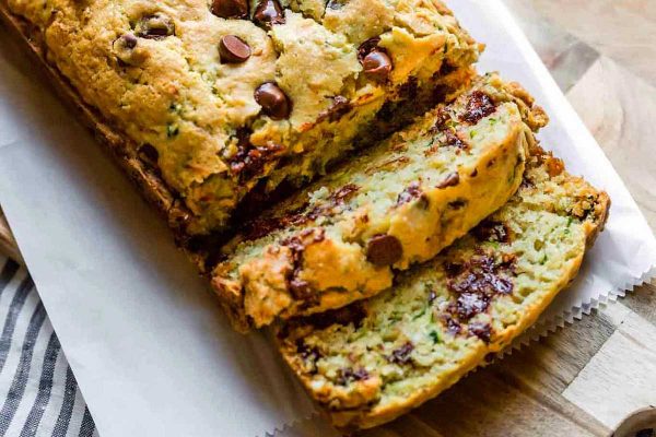 A slice of zucchini bread on a cutting board.