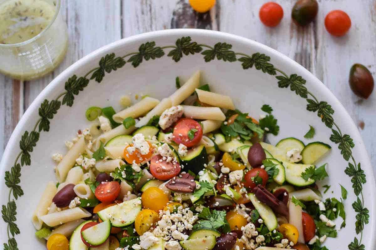 A bowl of salad with tomato and cucumber.
