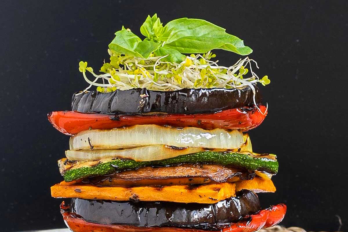A stack of roasted Zucchini on a plate.