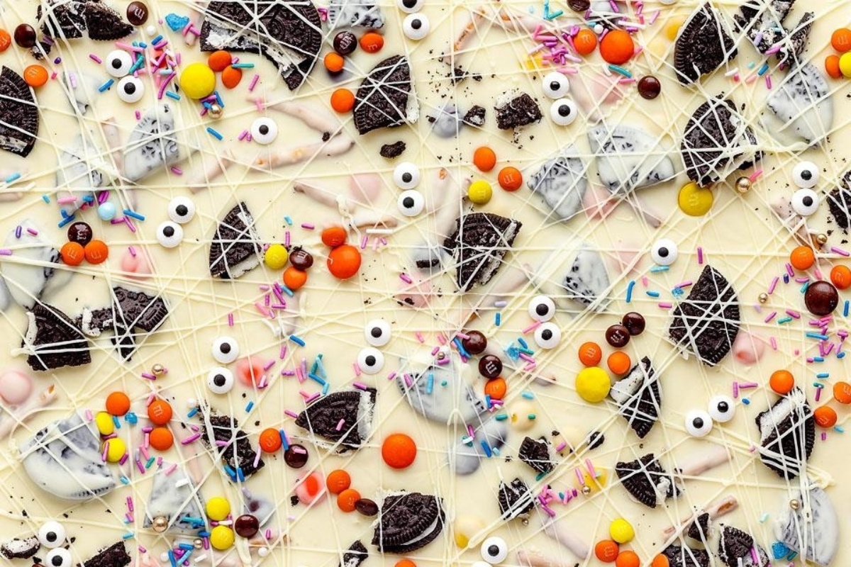 A delectable white chocolate bar adorned with colorful candies and delightful sprinkles.