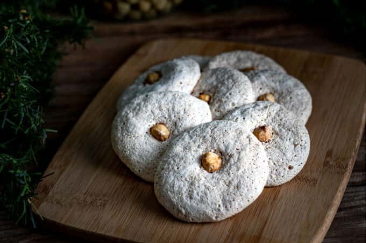 German cookies with nuts on a wooden cutting board.