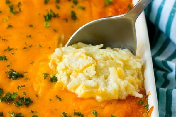 A spoonful of mashed potatoes in a white dish.