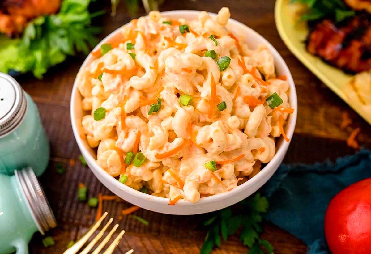 A pasta salad on a wooden table.
