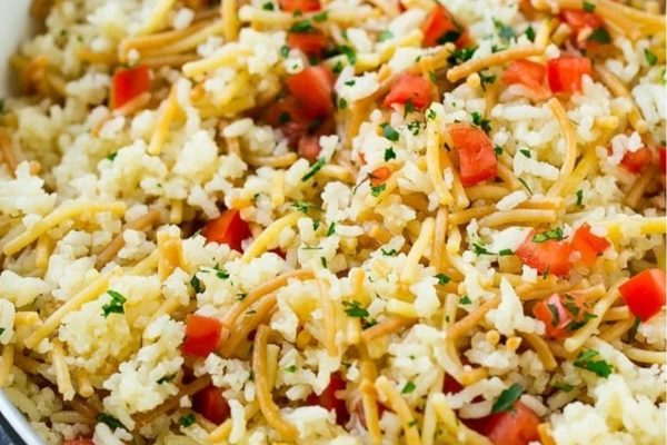 A colorful medley of rice and vegetables cooked to perfection in a pan, making it an ideal dish for utilizing pantry staples and exploring new recipes.