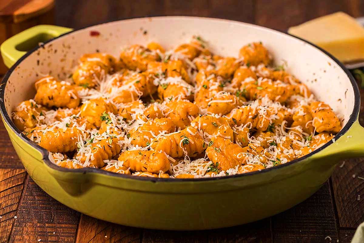 Fettuccine in a green pot with parmesan cheese. This is one of the best meatless recipes.