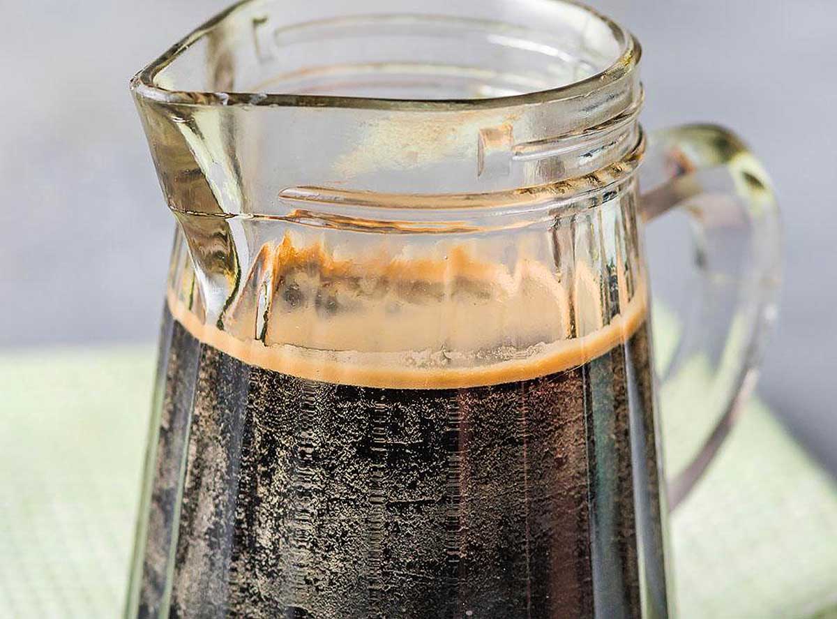 A mouthwatering glass pitcher filled with a delectable combination of coffee and ice cream.