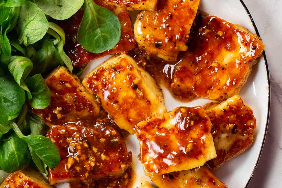 Tofu and spinach on a plate.