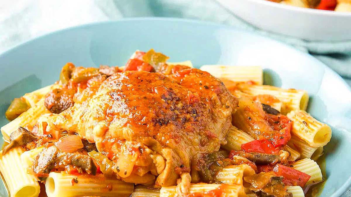 A bowl of Instant Pot pasta with chicken and vegetables.