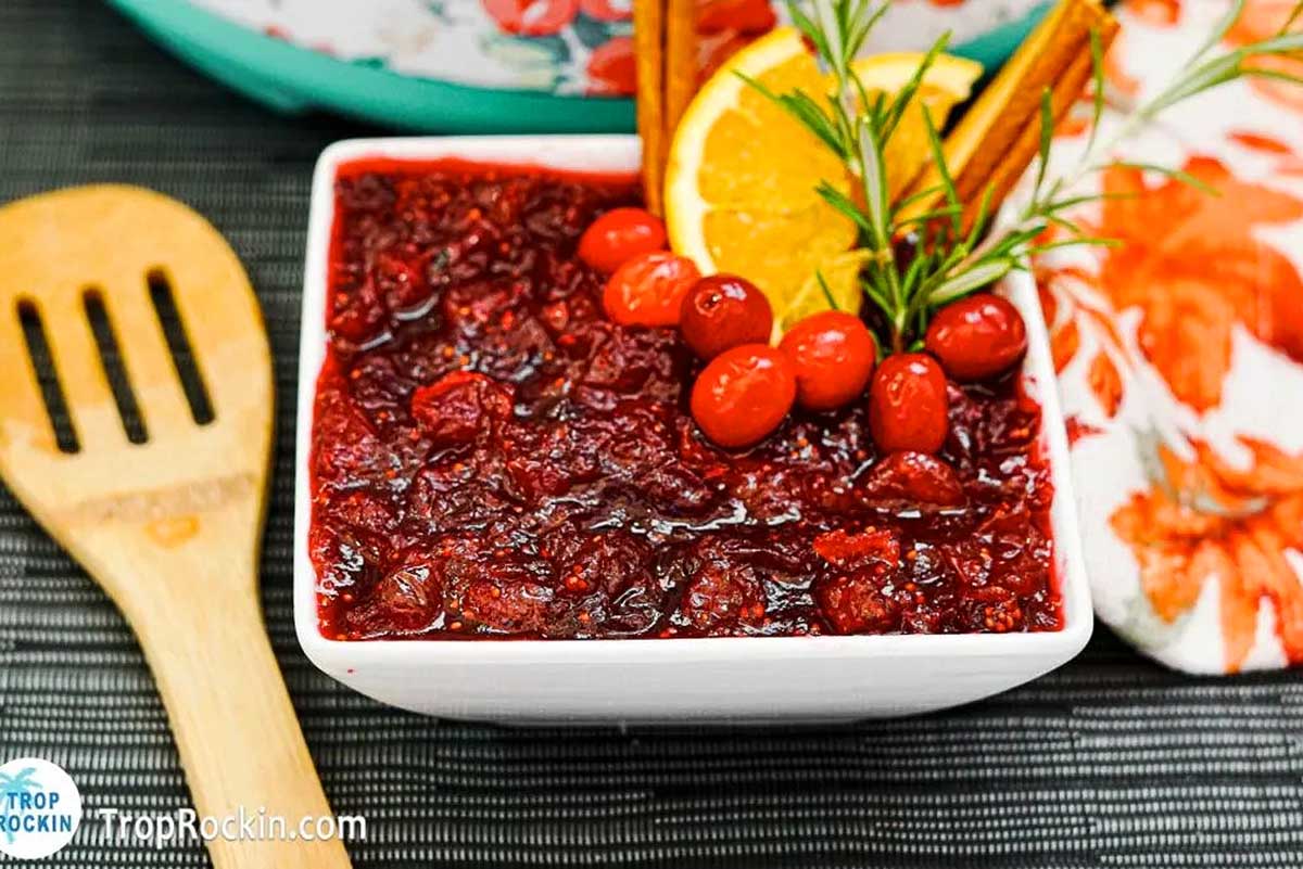 Cranberry sauce in a white bowl with Instant Pot and Thanksgiving.