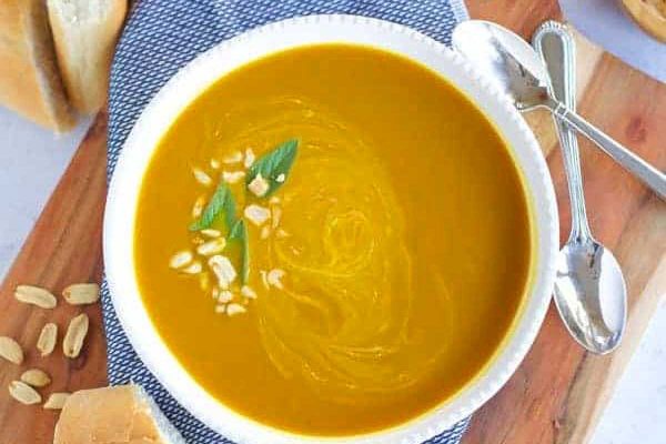 A bowl of pumpkin soup on an Instant Pot.