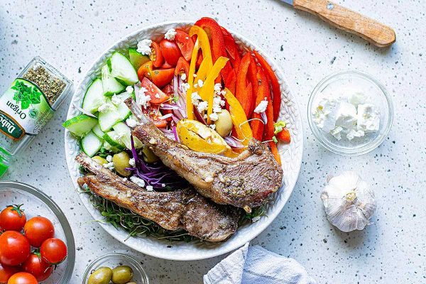 A bowl of salad with meat and vegetables.
