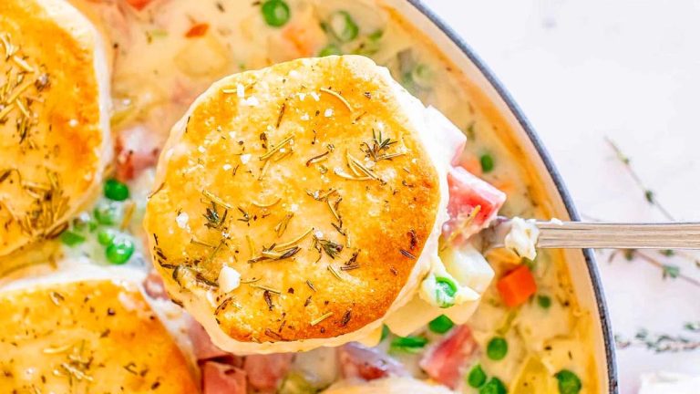 A spoon scooping ham pot pie.