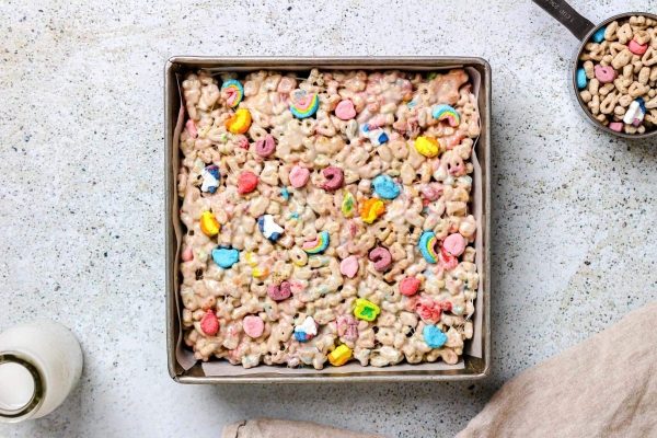 A box of cereal bars on a table next to a bowl of cereal.