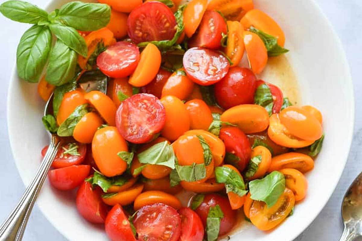 Tomato and basil in a white bowl, perfect for creating delicious recipes.