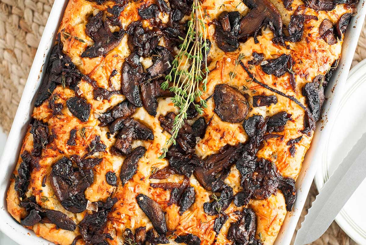 An amazing casserole with mushrooms and thyme, perfect for any occasion, served on a white plate.