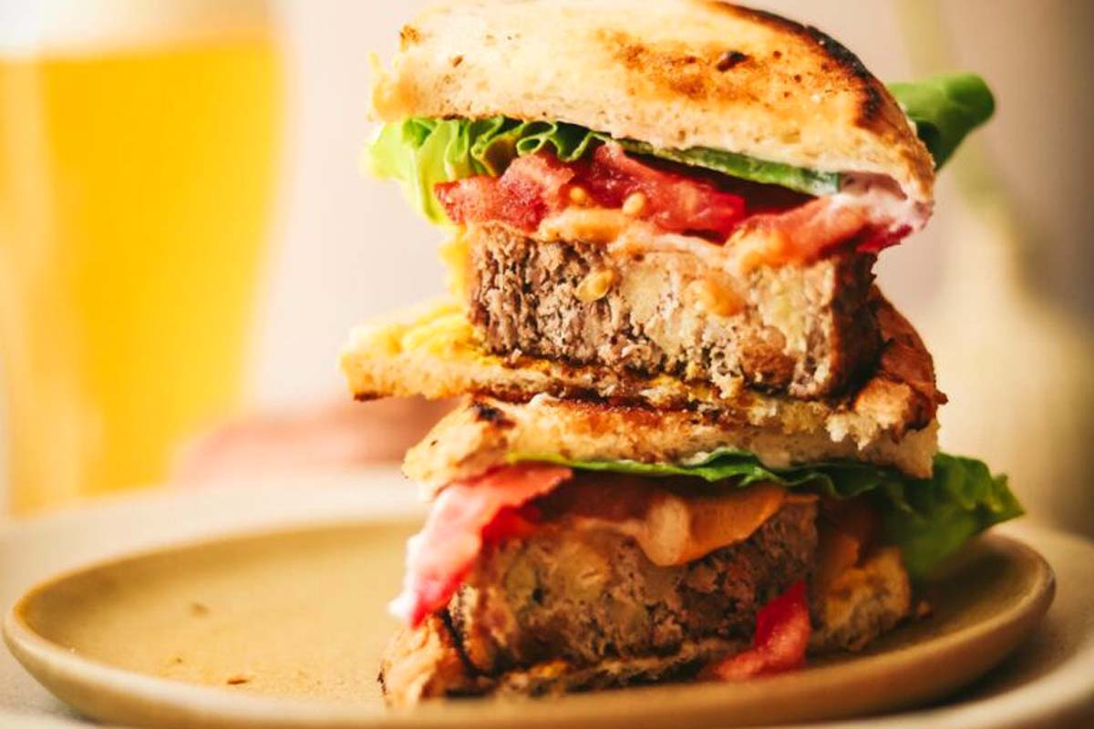 A stack of burgers on a plate.