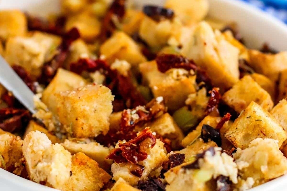 A white bowl filled with delicious stuffing, ready to be enjoyed with a fork.