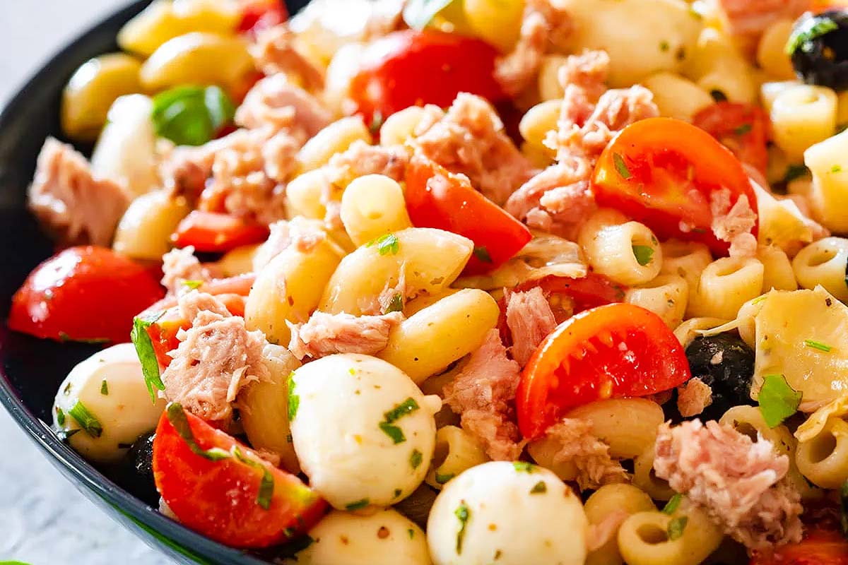 An Italian pasta salad recipe with tuna, tomatoes, and basil.