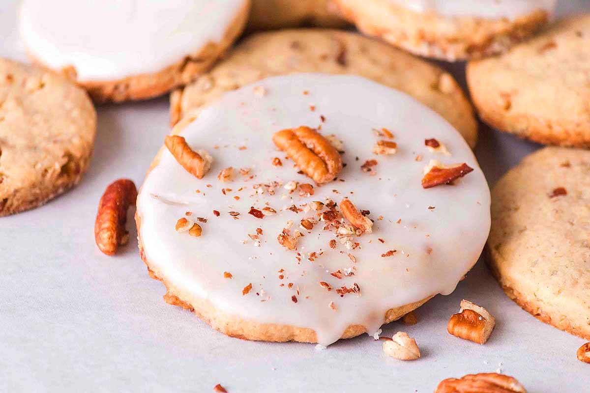Pecan cookies with icing and pecans - the ultimate treat for pecan lovers. These delicious treats feature a buttery cookie dough packed with crunchy pecans, topped with a delectable icing