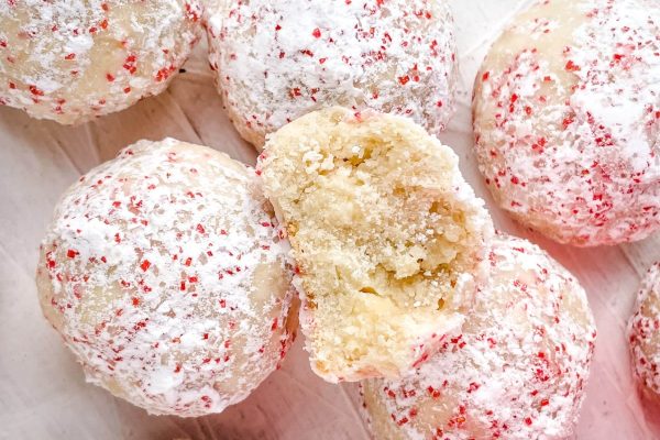 Peppermint sugar cookies with a bite taken out of them.