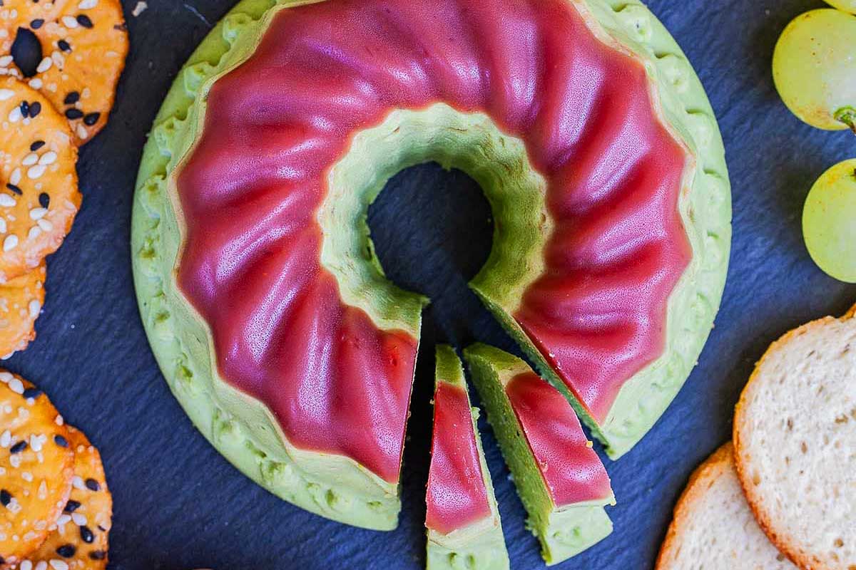 A slice of cheese with grapes, crackers, and pistachio recipes.