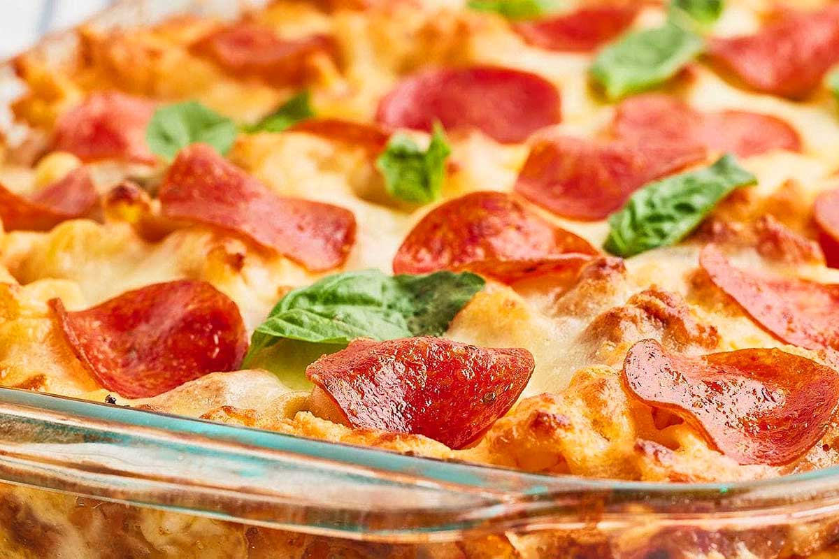 Pepperoni pizza casserole in a glass dish.