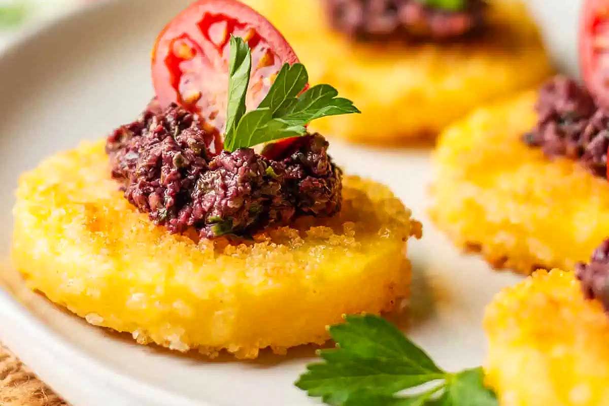 A plate topped with black bean and tomato appetizers.