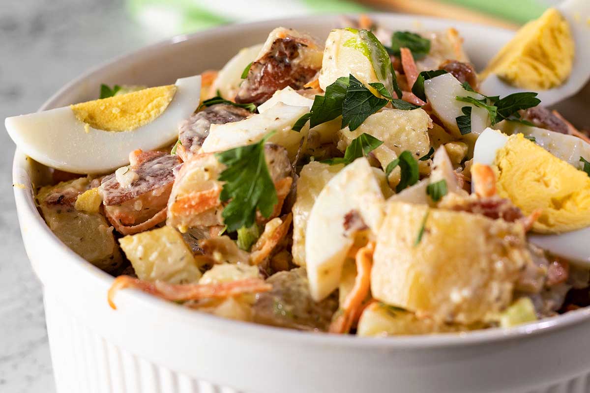A bowl of potato salad with hard boiled eggs.