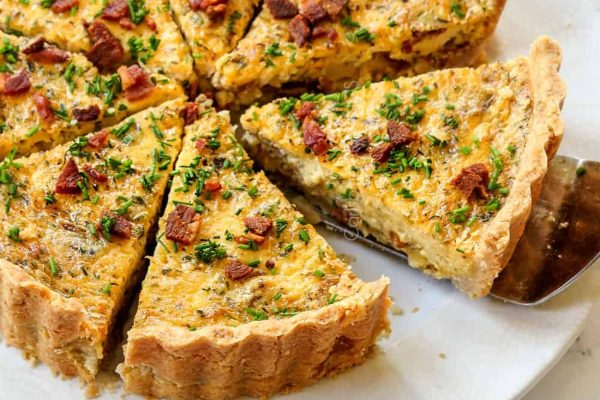 A bacon quiche served on a plate.