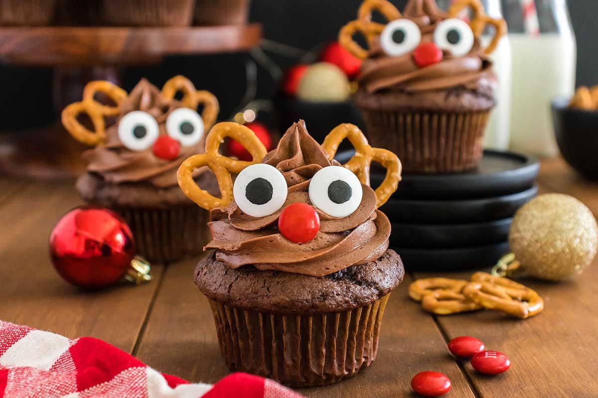 Cute Christmas cupcakes decorated with chocolate reindeer and pretzels.
