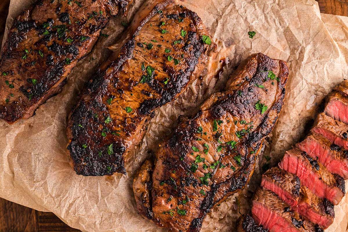 Three pieces of grilled steak on a piece of paper perfect for Date Night.