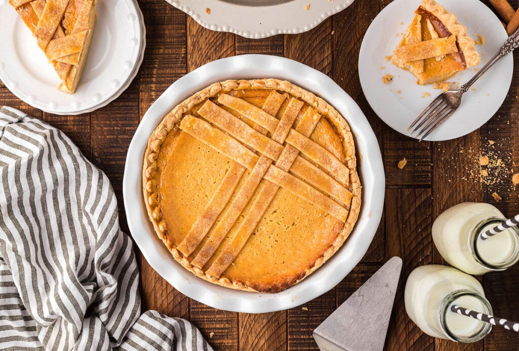 An Italian dessert, a slice of pumpkin pie, rests gracefully on a rustic wooden table.