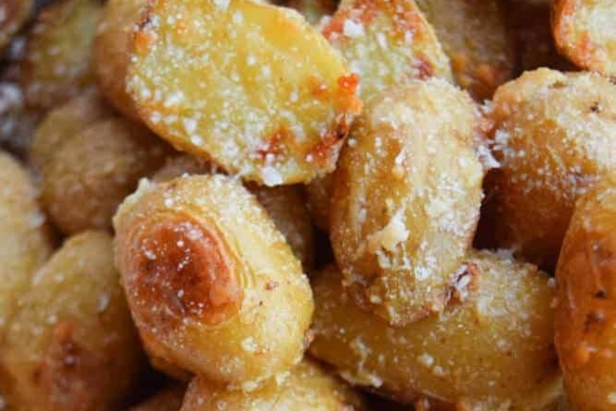 A close up of roasted potatoes with parmesan.