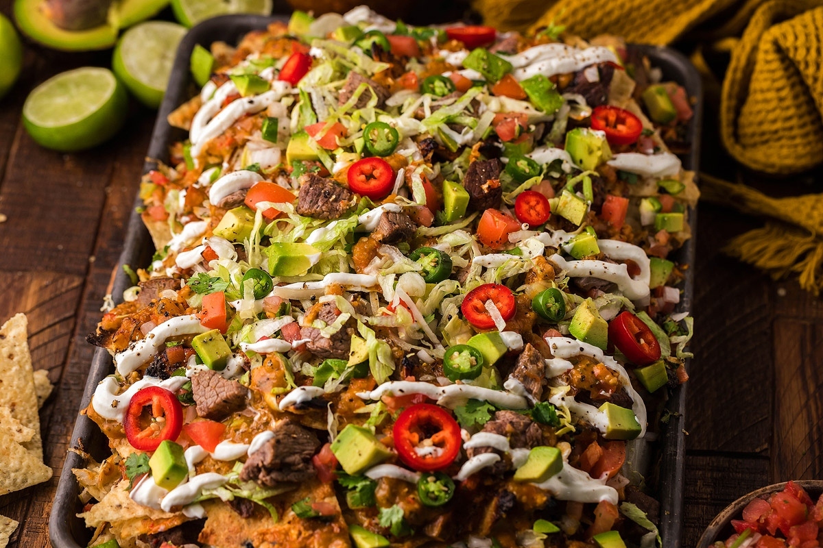 Mexican nachos on a wooden table. These are one of the best nacho recipes.
