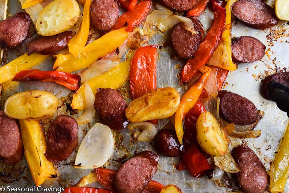 Thanksgiving Sheet Pan Recipe: Sausage and peppers on a baking sheet.