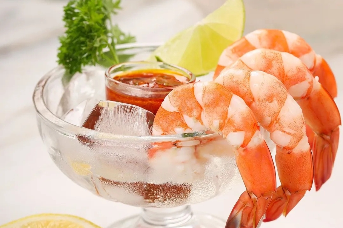 Appetizers: Shrimp in a glass bowl with lemon and lime wedges, perfect for New Year's Eve.